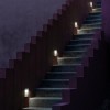 Applique Real Matter acier brossé Flos Valente Design mise en scène escalier