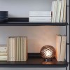 Lampe à poser PLANET fumé Kartell - Valente Design mise en scène éclairée dans bibliothèque